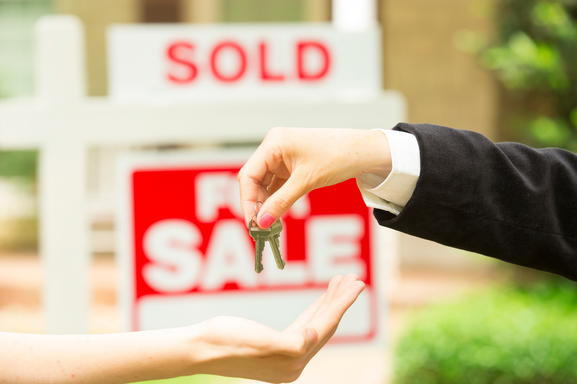 Handing keys over for a newly sold home.