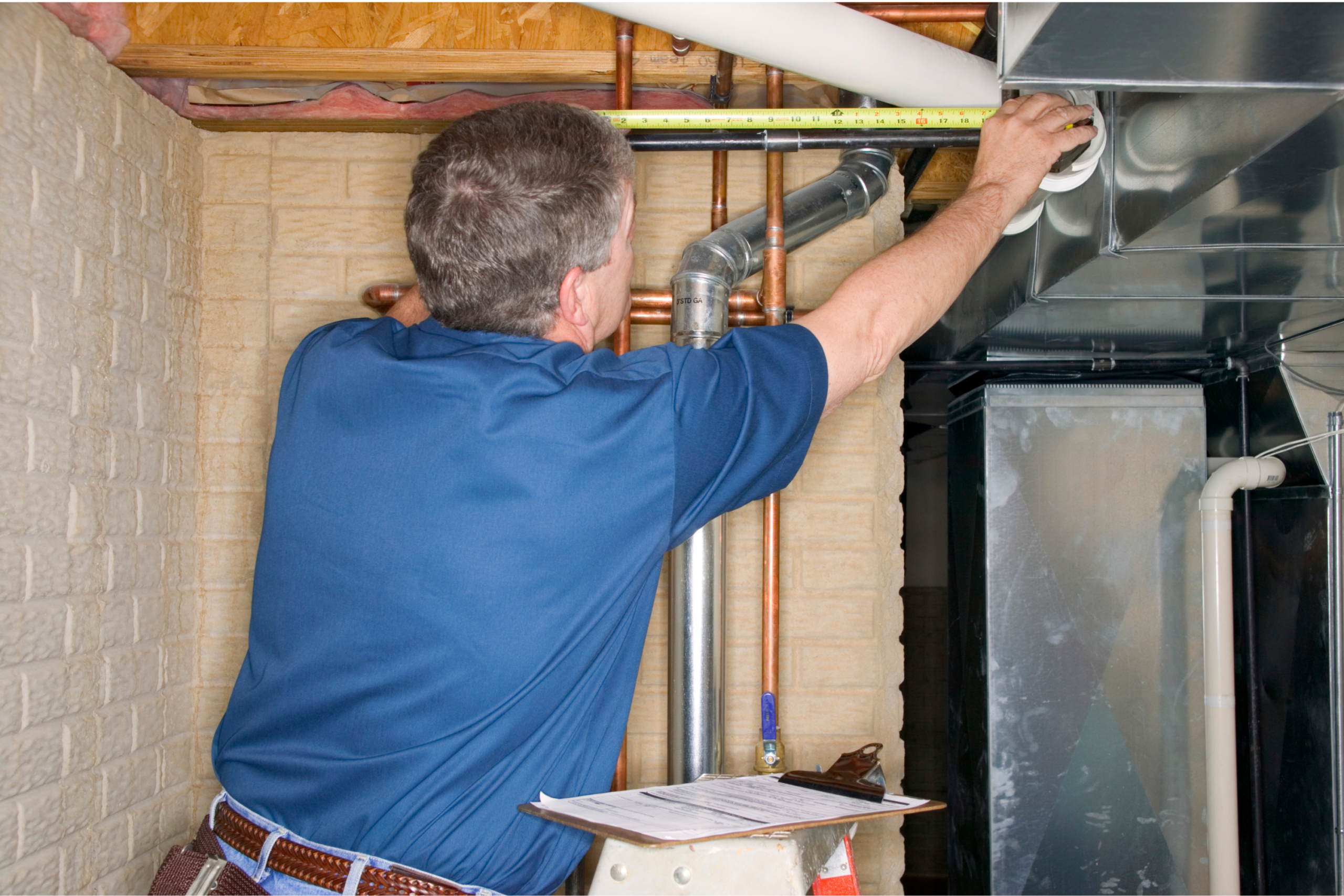 Inspector measuring the length of a pipe.