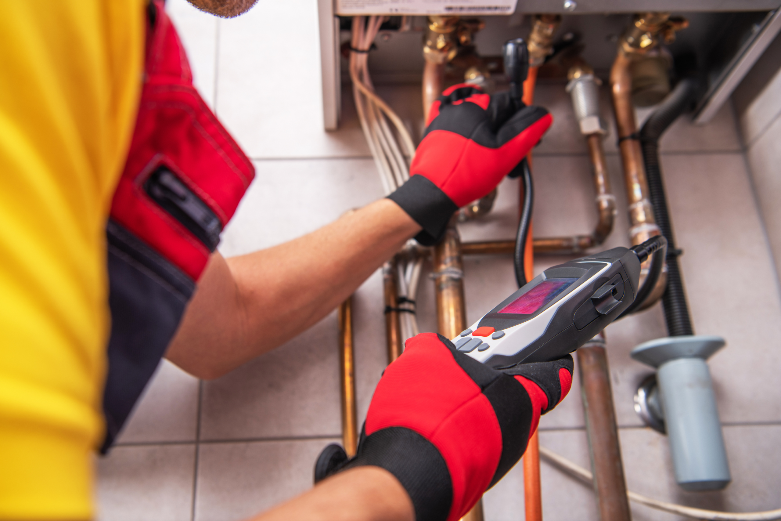 Professional using special equipment to check pipes.
